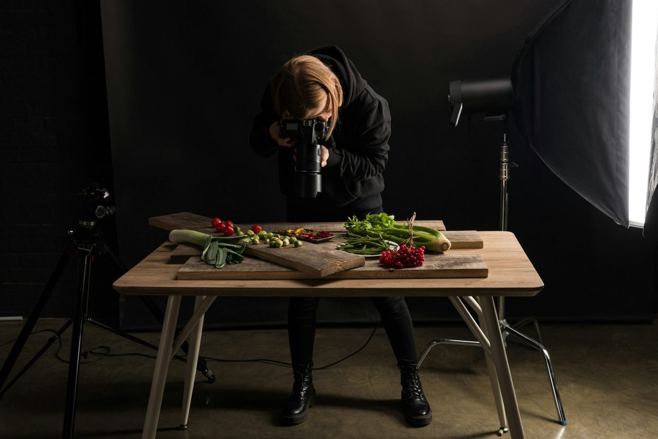 Home 1 female photographer making food composition for commercial photography and taking photo on digital